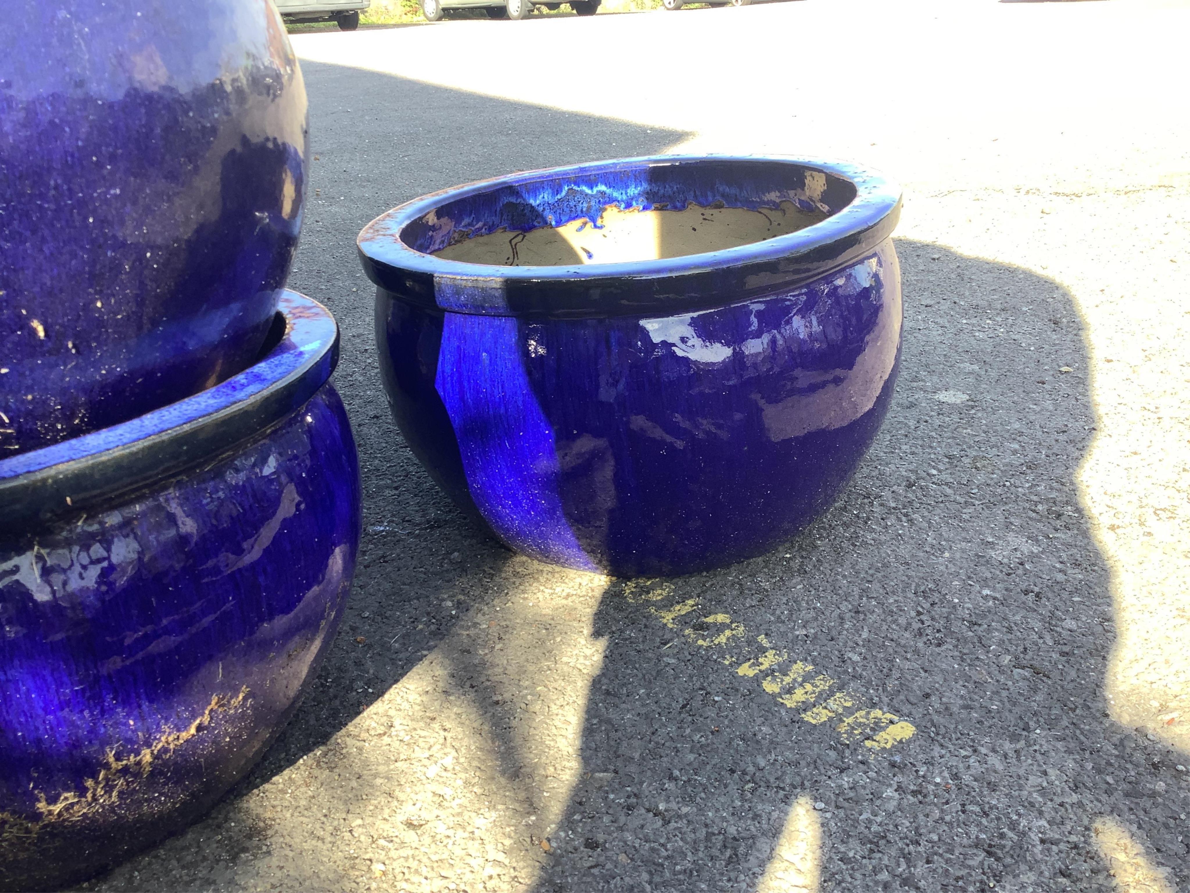 Nine circular dark blue glazed earthenware garden planters, diameter 53cm, height 31cm. Condition - fair